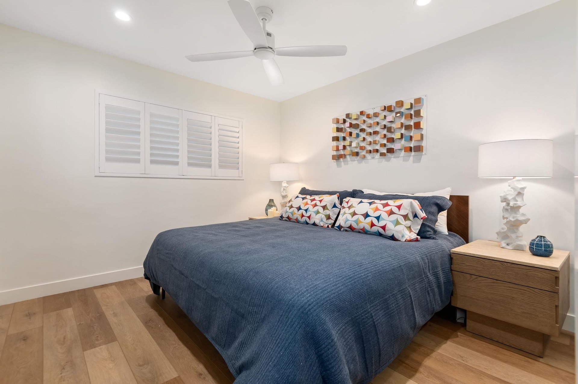 Primary bedroom with a King bed, end tables, and plenty of storage.