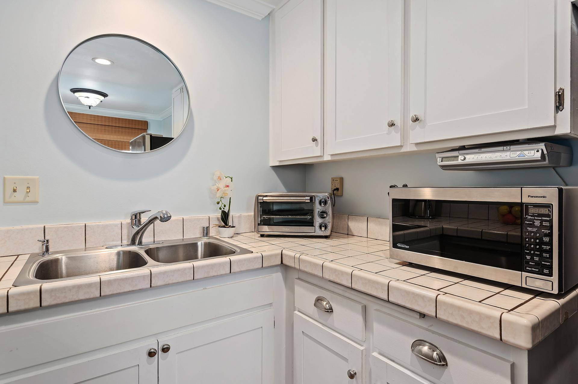 Kitchen has toaster oven, microwave and coffee maker