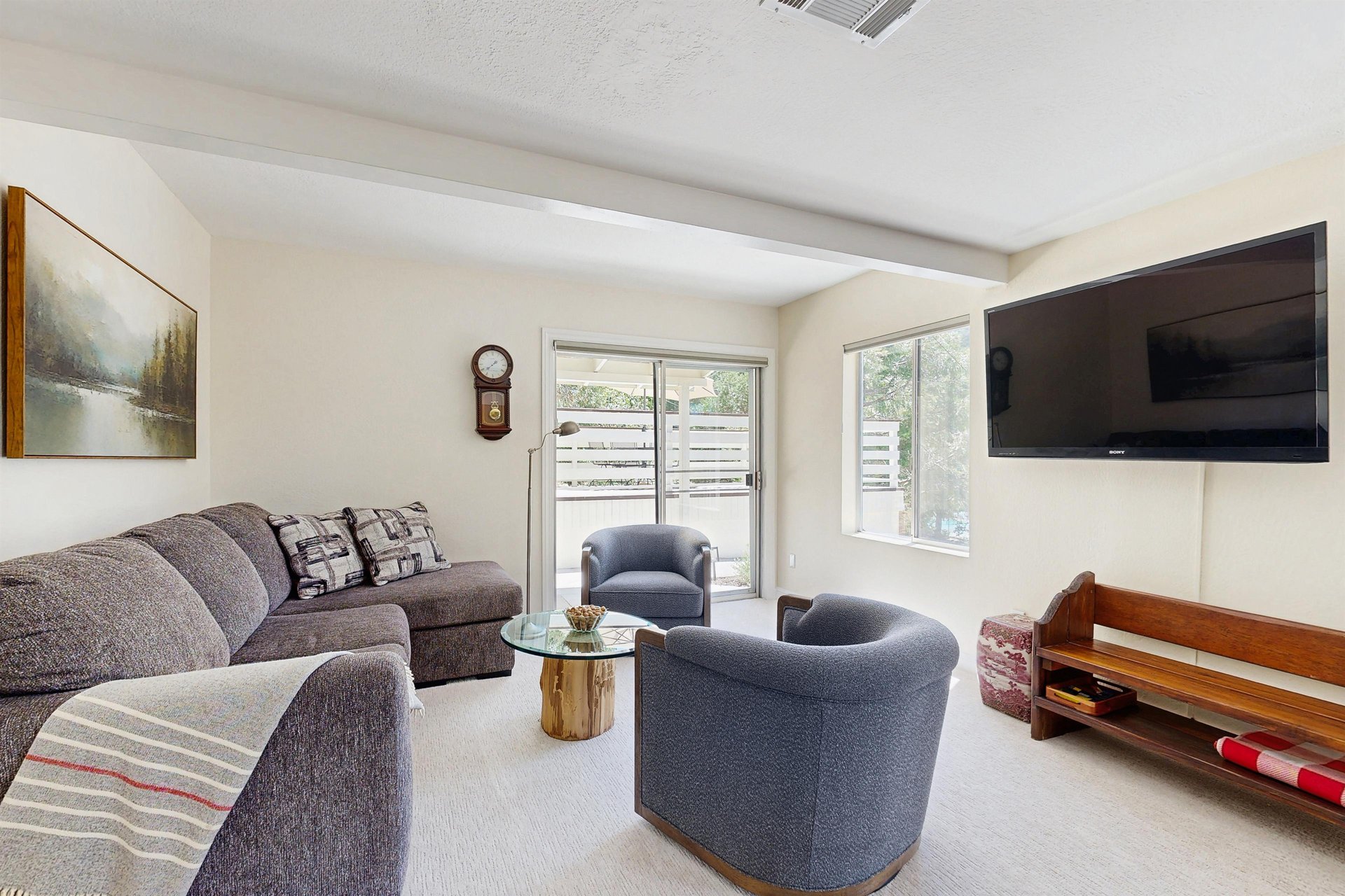 Located on the lower level of the home with ample seating, flatscreen TV, full bathroom, and an additional sitting area with a fireplace.
