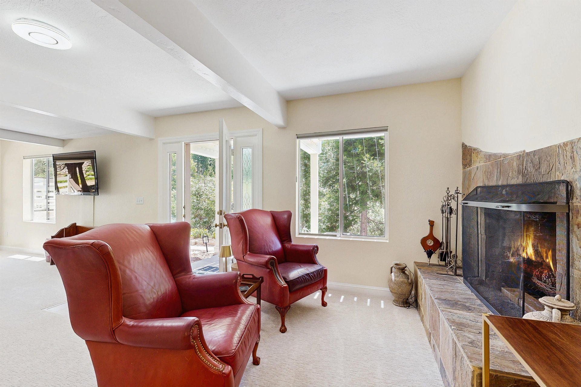 Located on the lower level of the home with ample seating, flatscreen TV, full bathroom, and an additional sitting area with a fireplace.