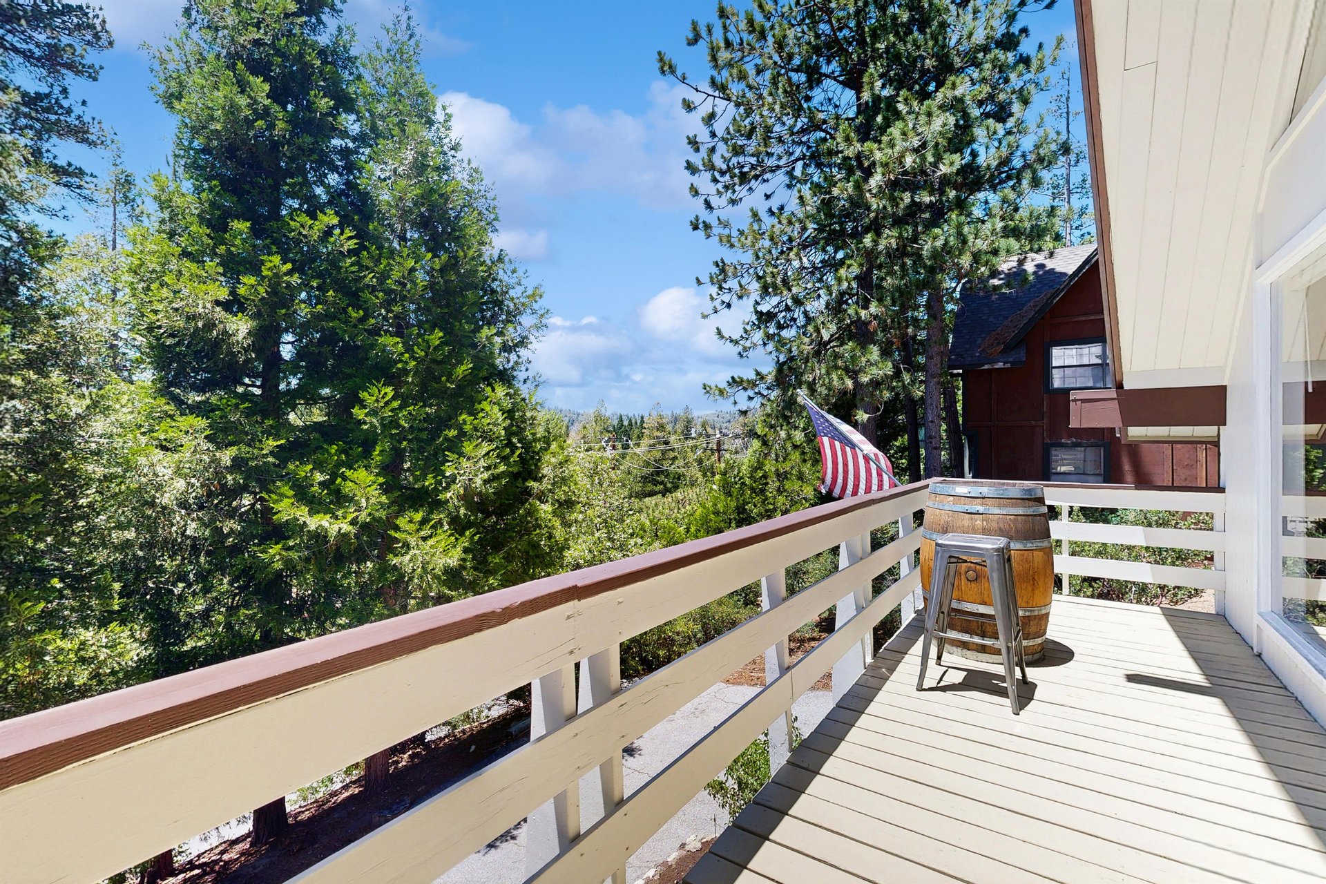 Deck located just off of the kitchen and dining area with mountain and forest views.