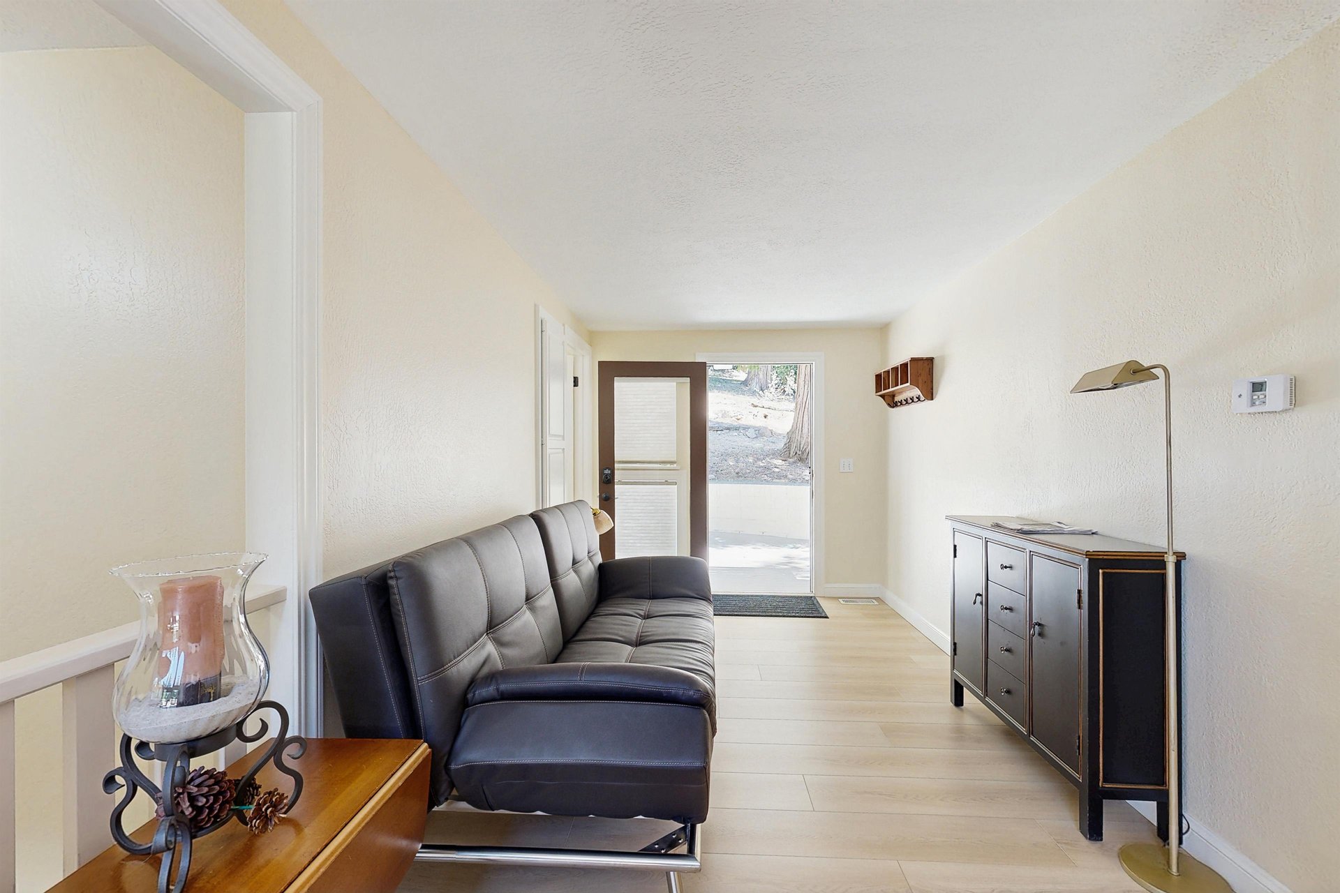 Entryway located on the main level level 2, leading to dining area, kitchen, and 2 guest bedrooms.