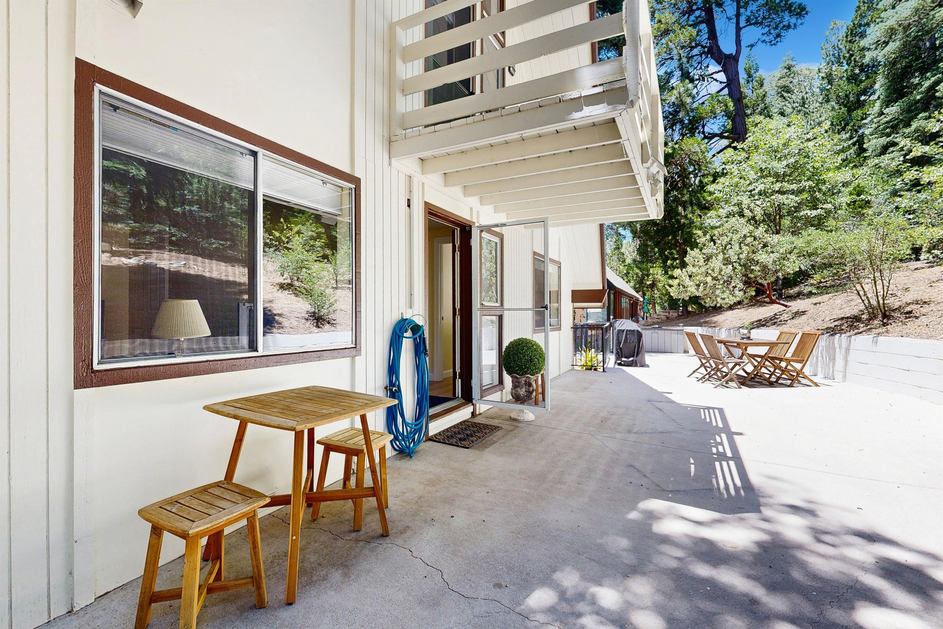 Back patio with outdoor seating, dining area, and BBQ grill.
