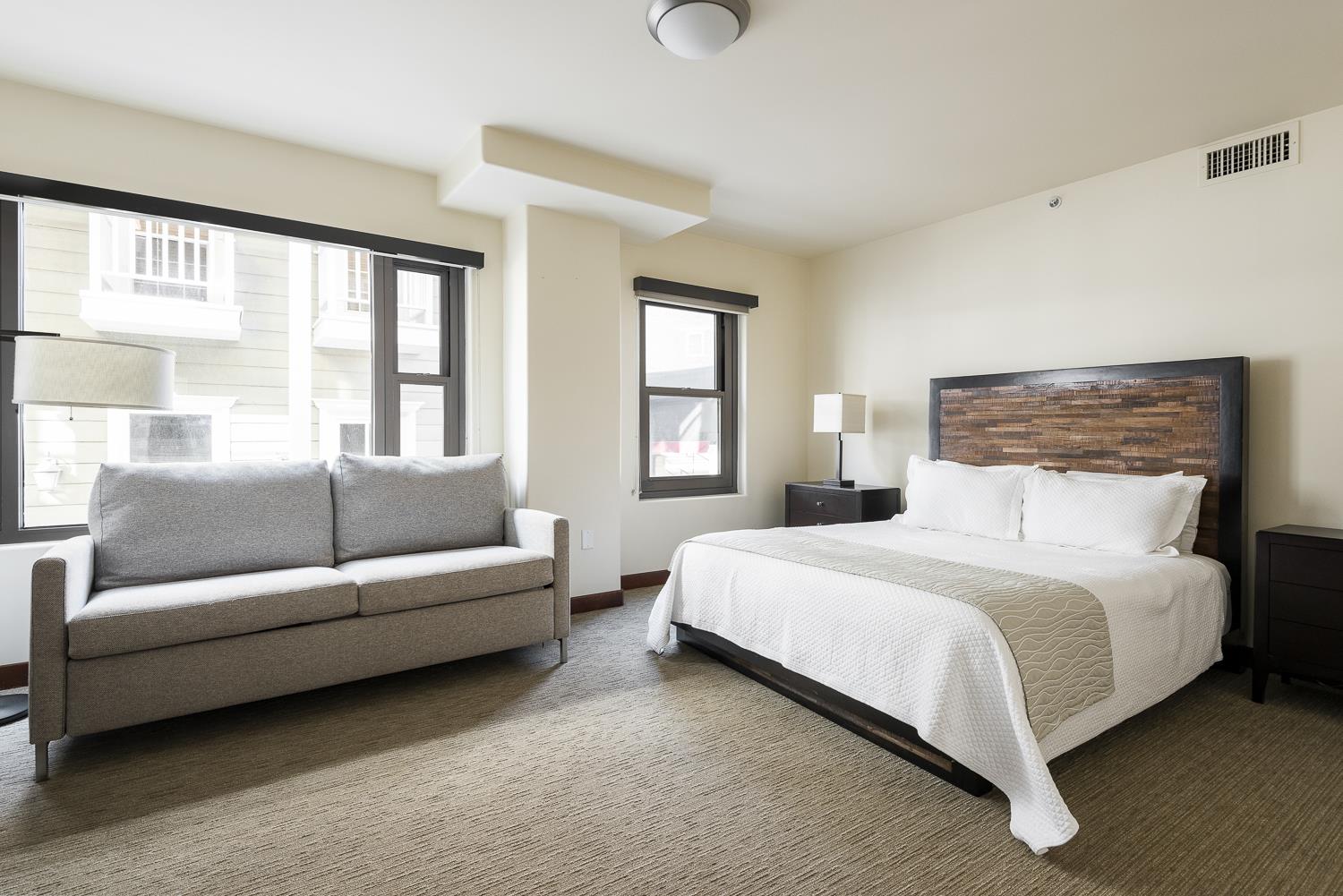 Guest bedroom with queen and grey queen sofa sleeper