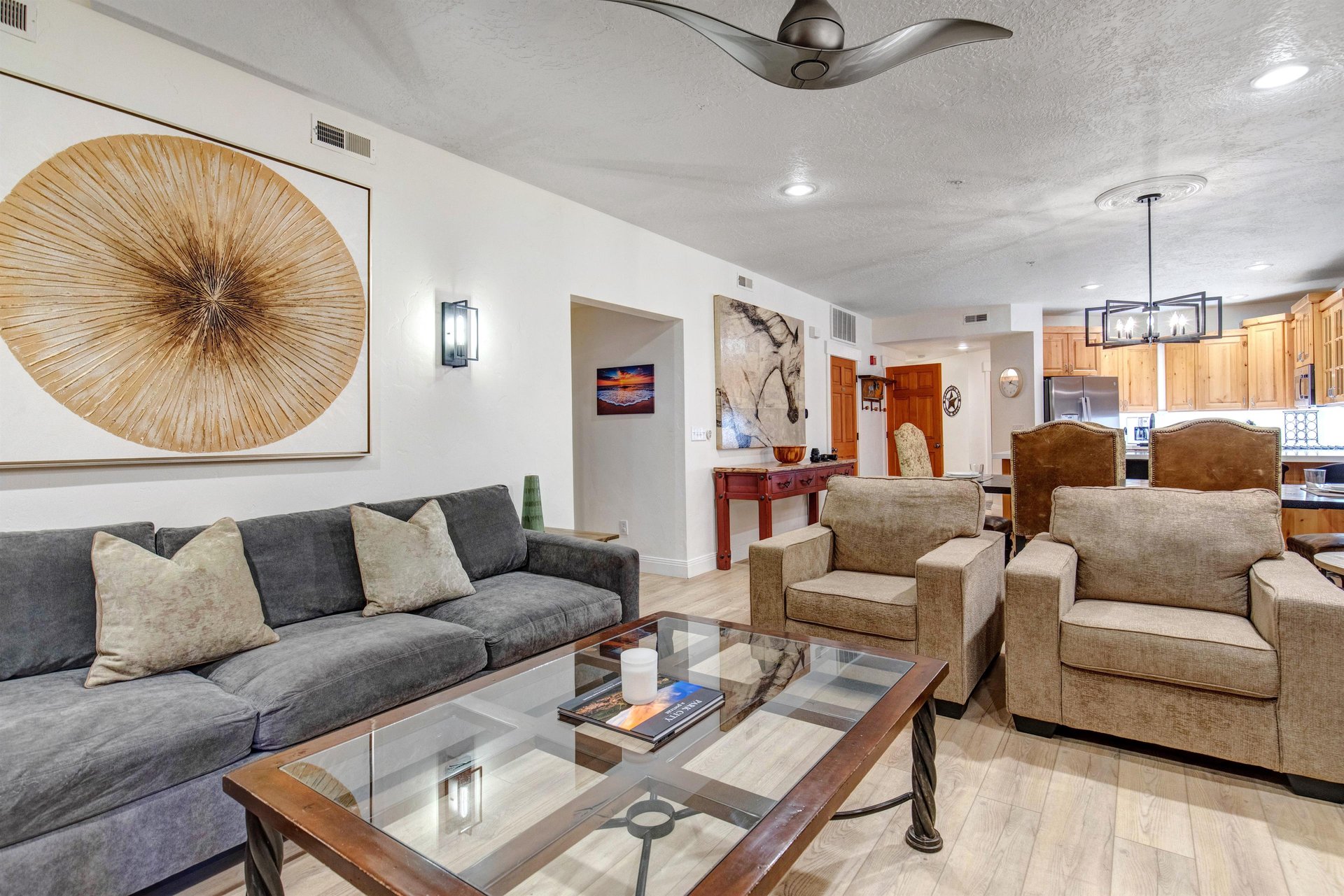 Youll love relaxing in this airy, artfilled living space that flows seamlessly into a fullyequipped kitchen and dining area.