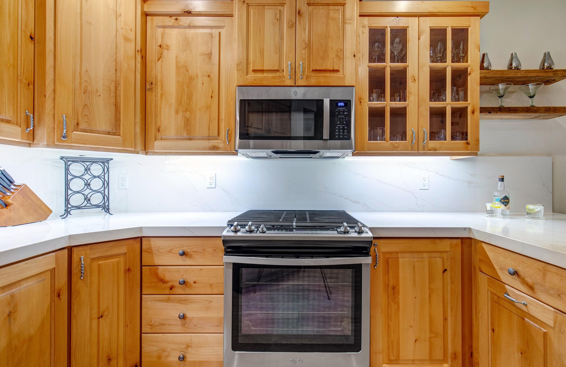 Cook up your favorite meals in this fullyequipped kitchen featuring warm wood cabinetry and plenty of counter space.