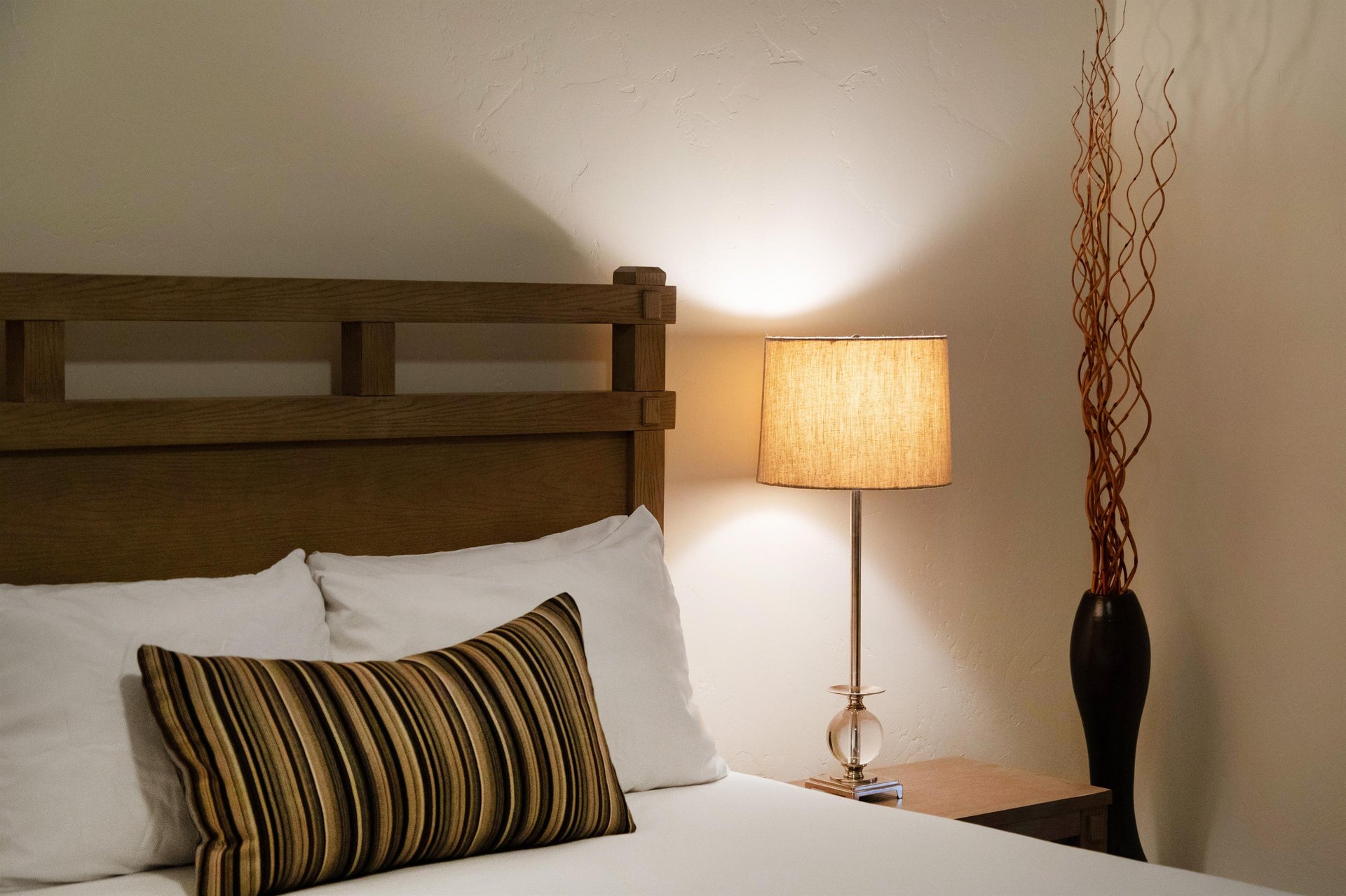 The queen bed in the second bedroom offers crisp linens and plush pillows.