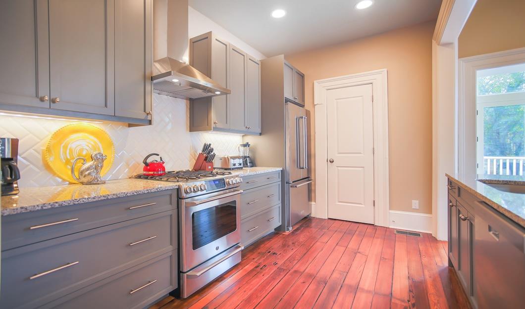 Large kitchen cabinets, stainless steel appliances and herringbone back splash is modern luxury.