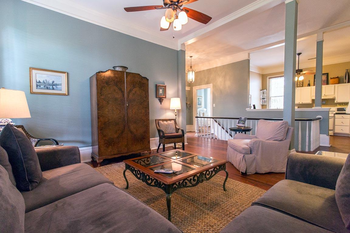 The kitchen is on the other side of the stairs.