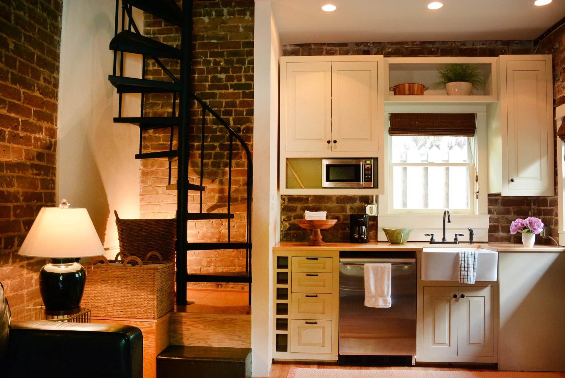 The spiral staircase leads up to the bedroom.