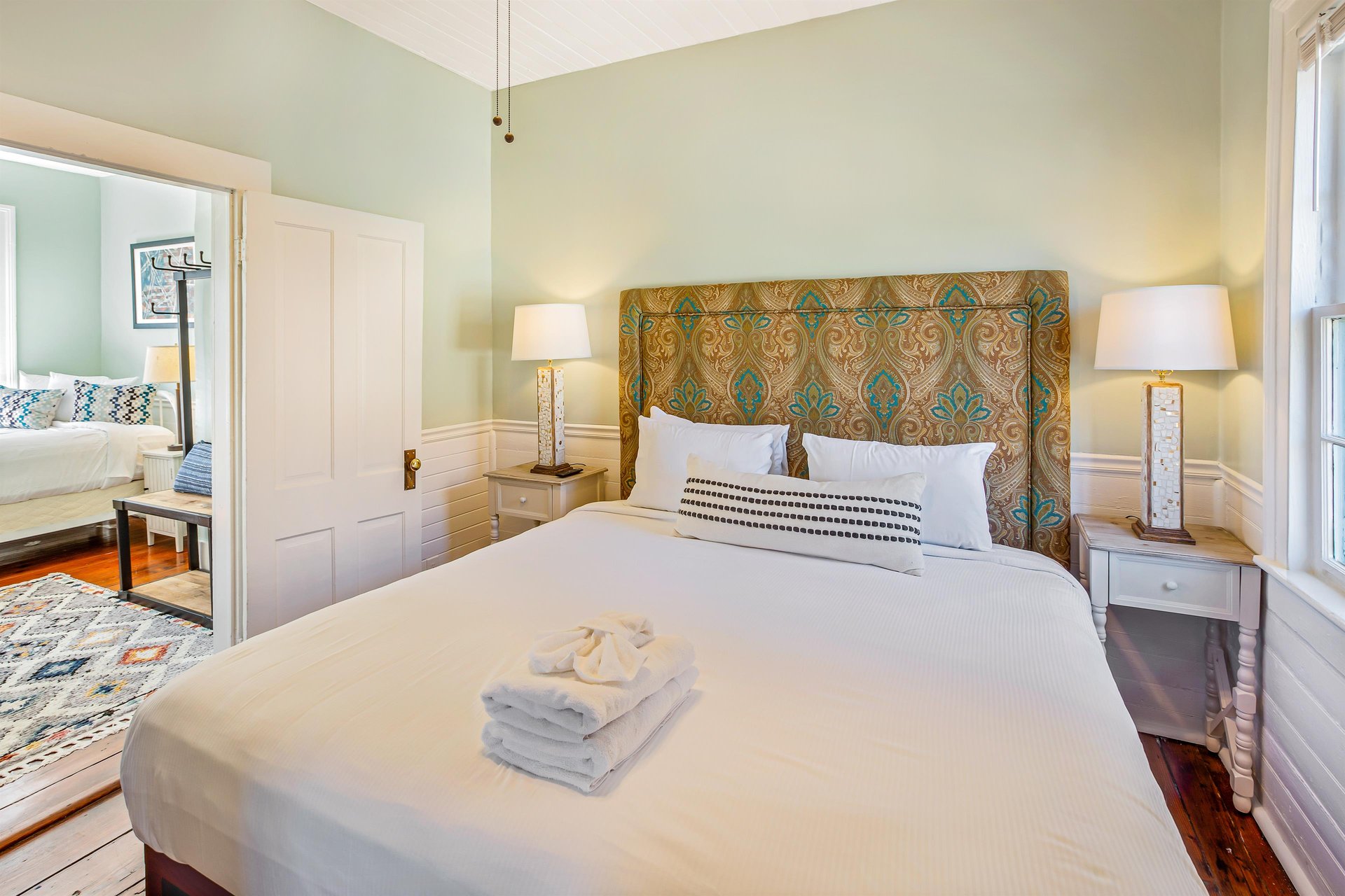 The king size bed fits perfectly in this quaint room, with two matching night stands.