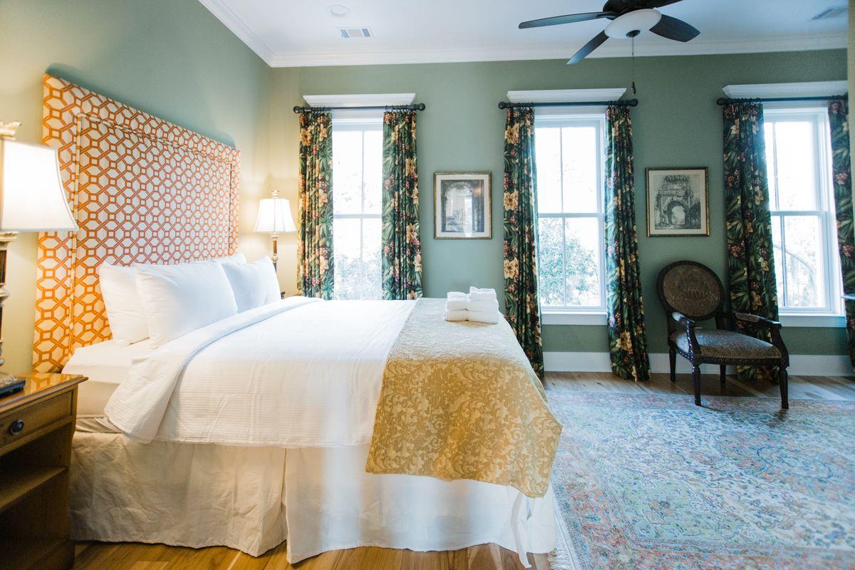 A plush queensize bed fitted with white, crisp linens.