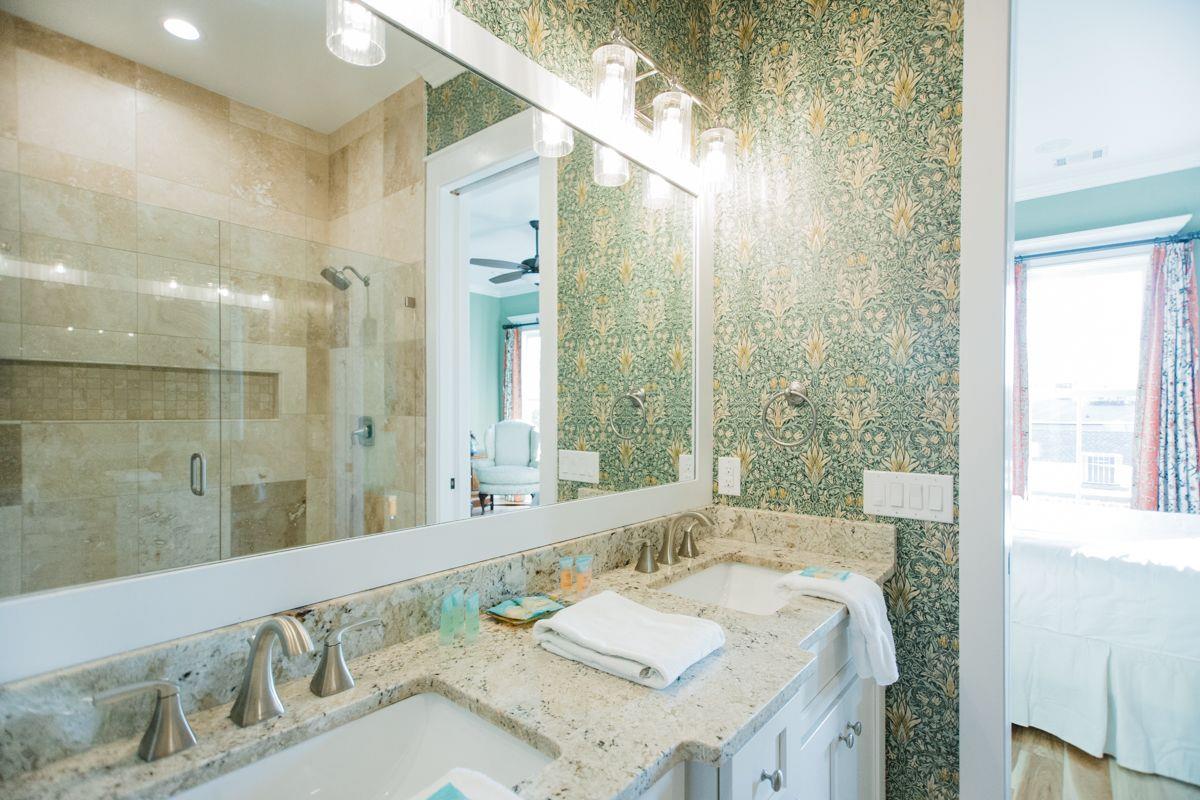 A dual vanity, with plenty of storage is offered in this upscale en suite bathroom.