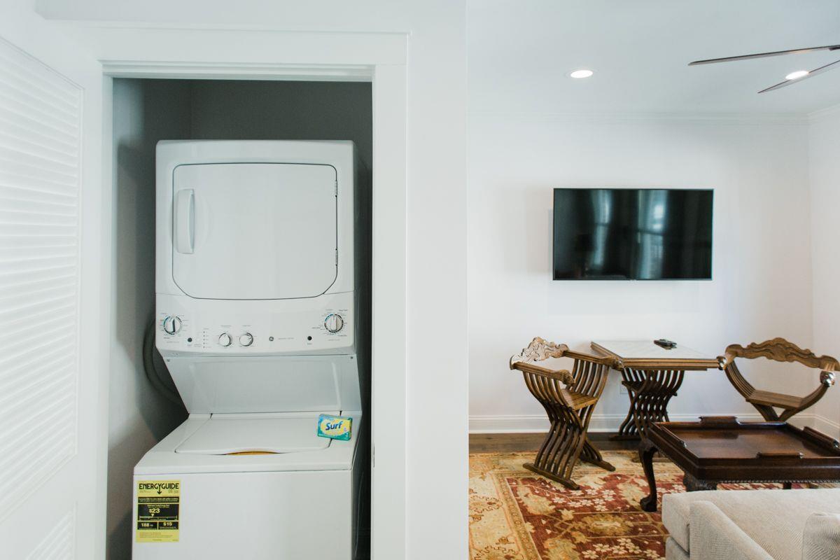 A fullsize stackable washer and dryer is conveniently tucked away.