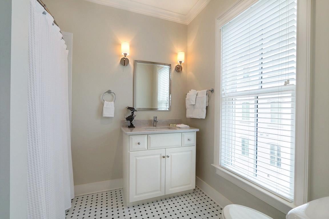 The guest bath has traditional tile floors and a tubshower combo.