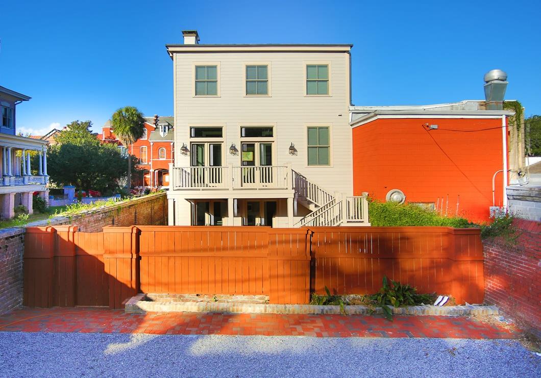 Parking for two cars in the back of the home as well as a courtyard beyond the fence.