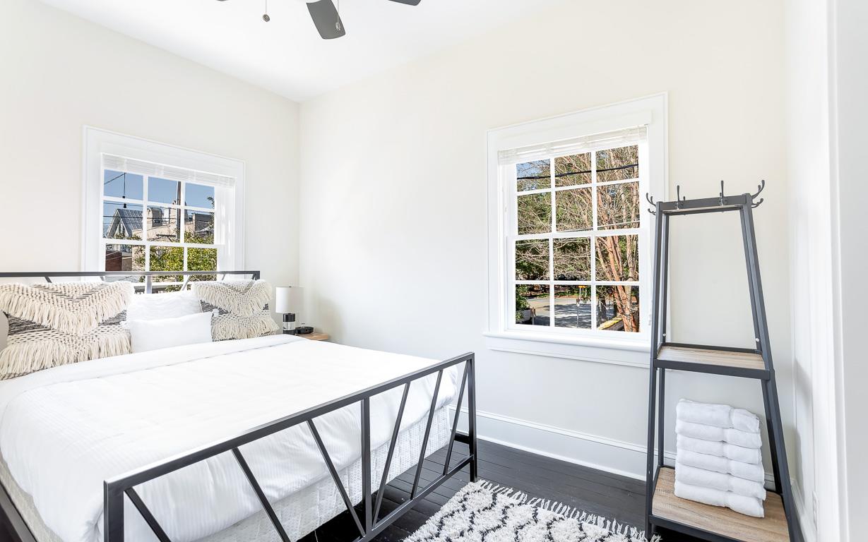 The bedroom faces Calhoun Square, fitted with a queen bed.