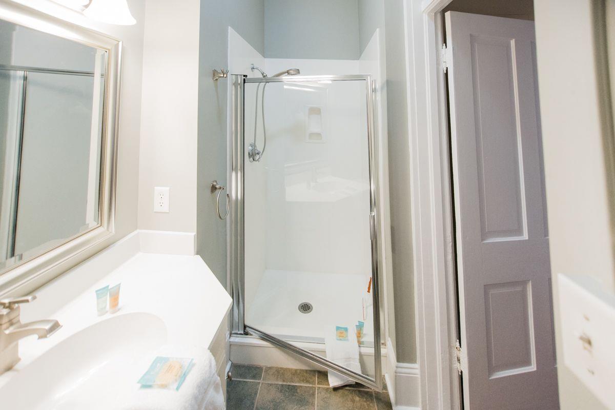 A standing shower, and large vanity is offered.