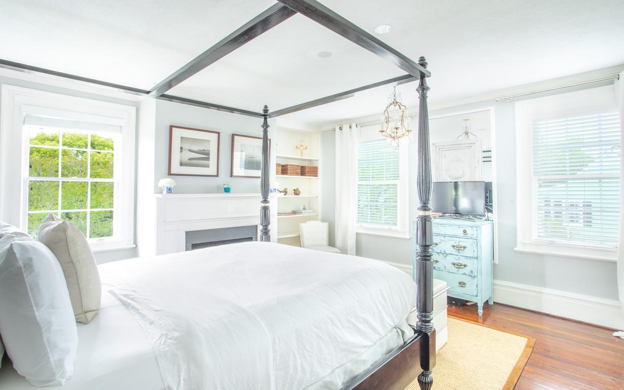 A TV sits opposite of the bed for latenight shows.