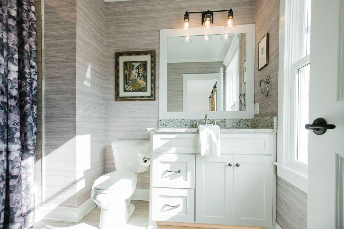 The ensuite bathroom boasts with natural light.