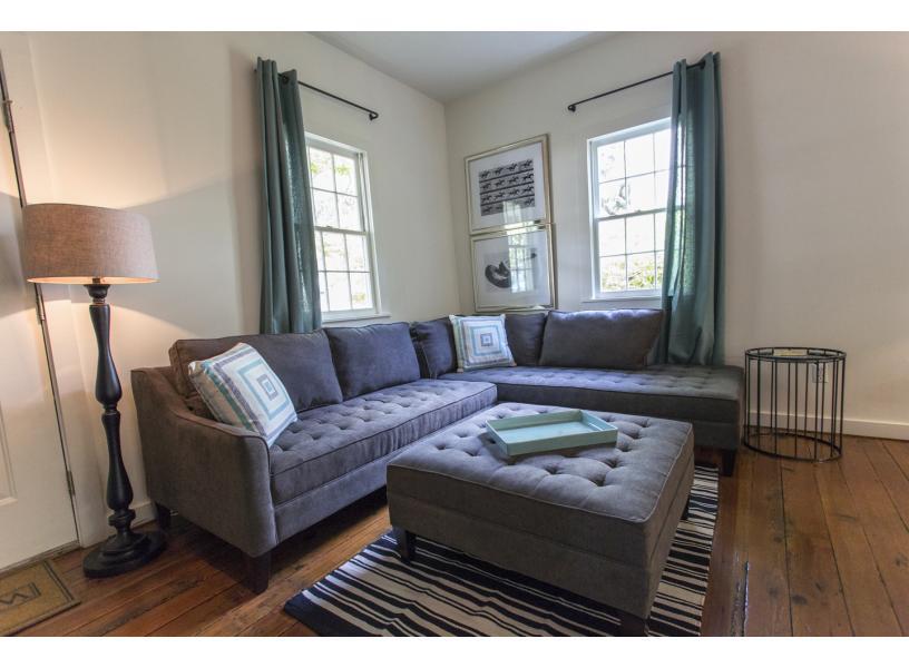 Large living room with sleeper sofa and two sitting areas.