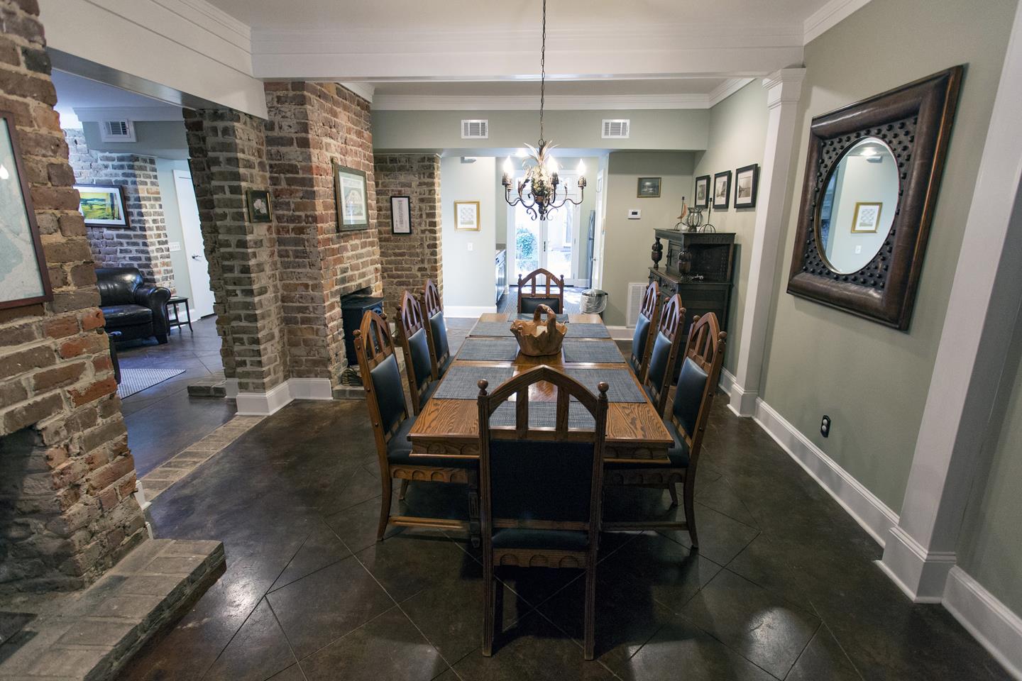 Original brick walls and lots of open space create an elegant dining room area.