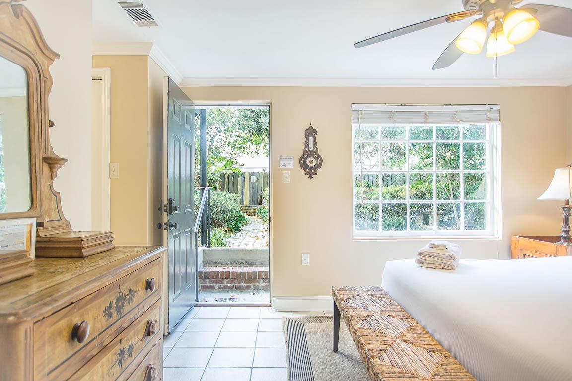 The bedroom door leads to the shared courtyard and private parking.