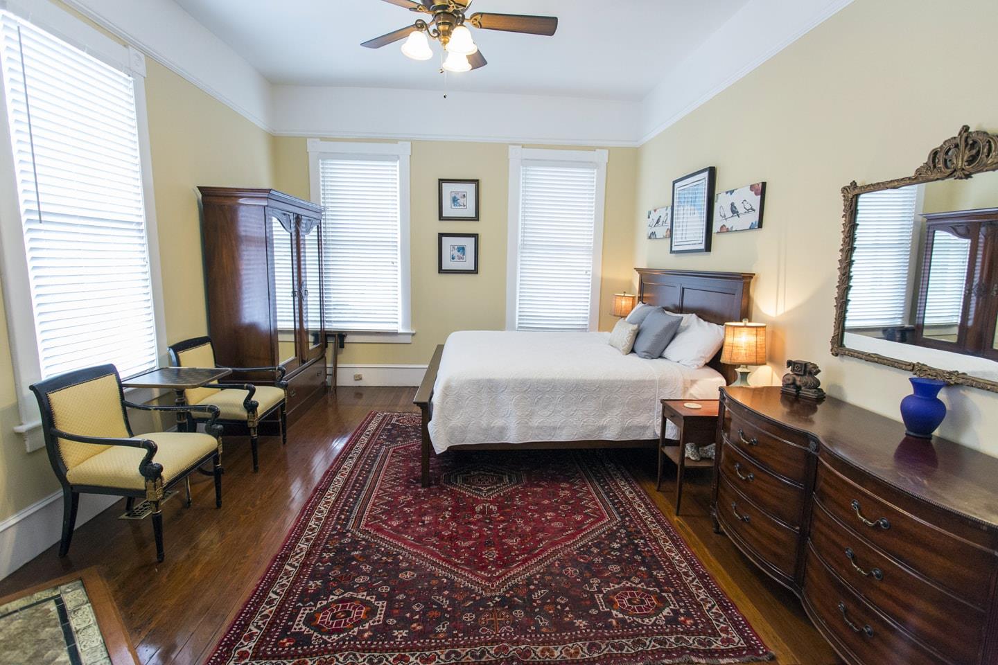 The original hardwood floors extend from the living room, through the classic pocket doors and into the primary bedroom.