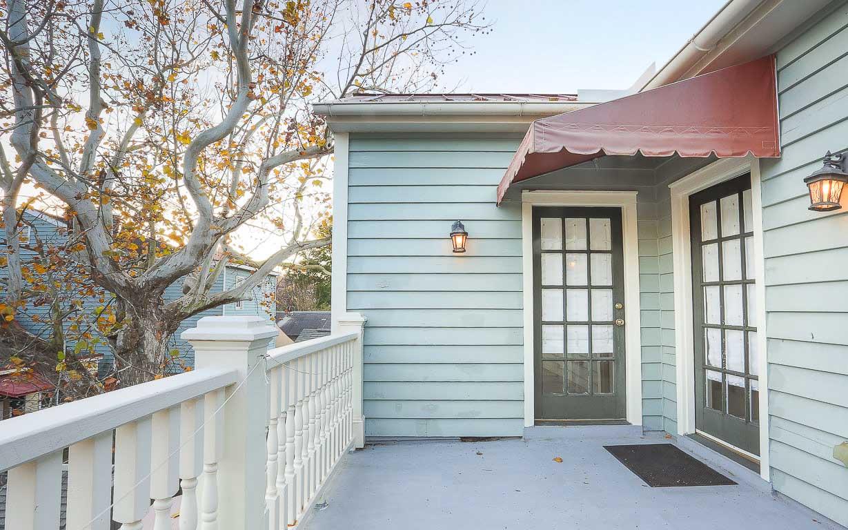 A private balcony is accessible from both the primary bath and the upstairs stairwell.