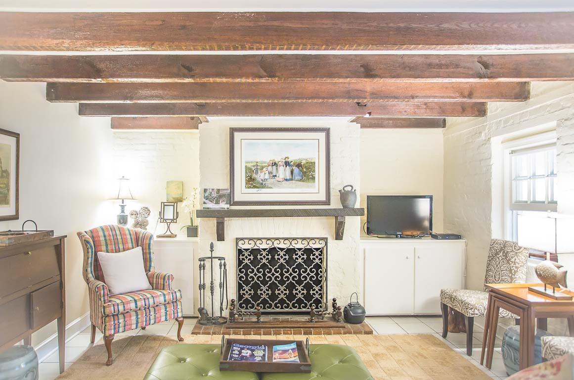 The original brick fireplace anchors the living room.