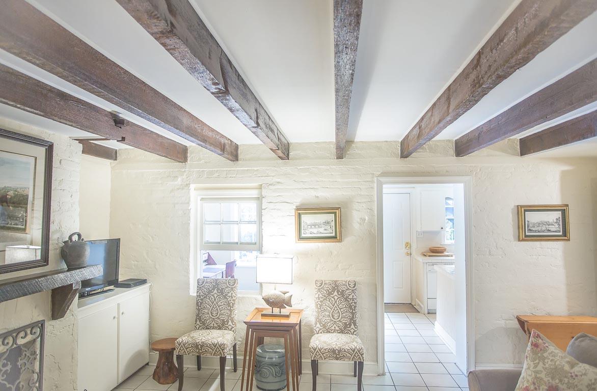A flat screen TV is to the right of the fireplace.