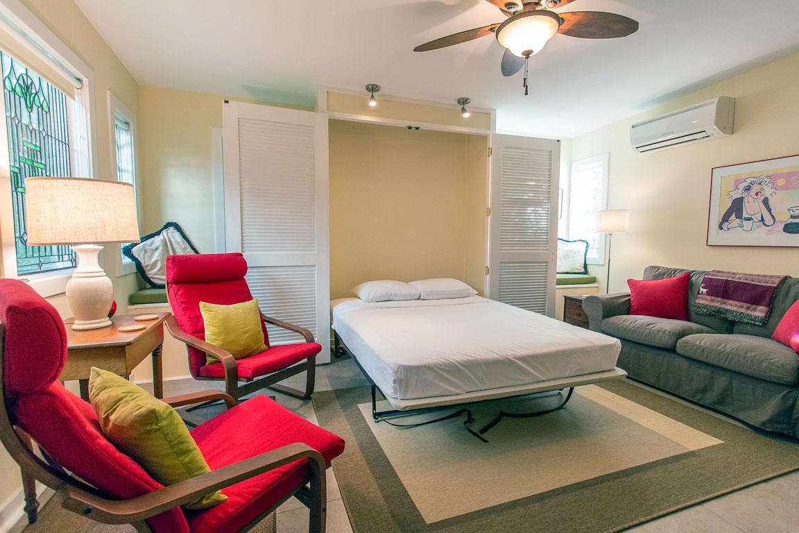 A Queen size Murphey bed folds out in the sun room.