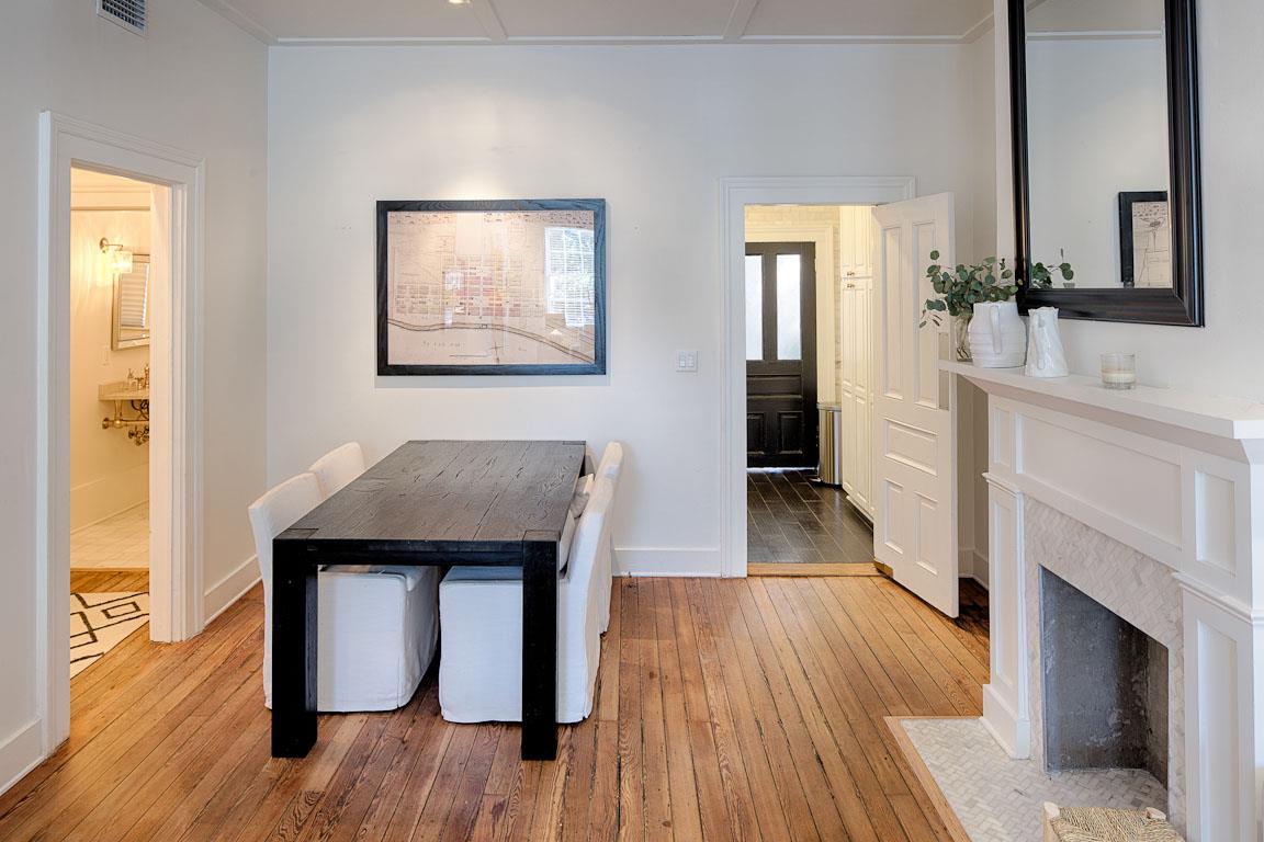 Two additional dining chairs can be found opposite the fireplace.