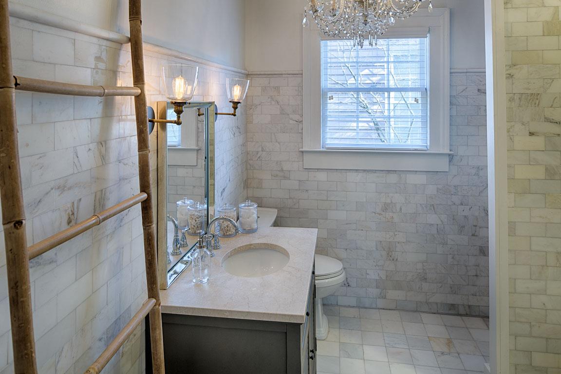 The primary bath has beautiful marble tile.