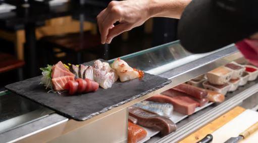 From the sushi bar to your table — Yuki Yamas chefs bring worldclass Japanese cuisine to Park Citys Historic Main Street Freshly plated sashimi assortment on slate board at Yuki Yama Park City Utah