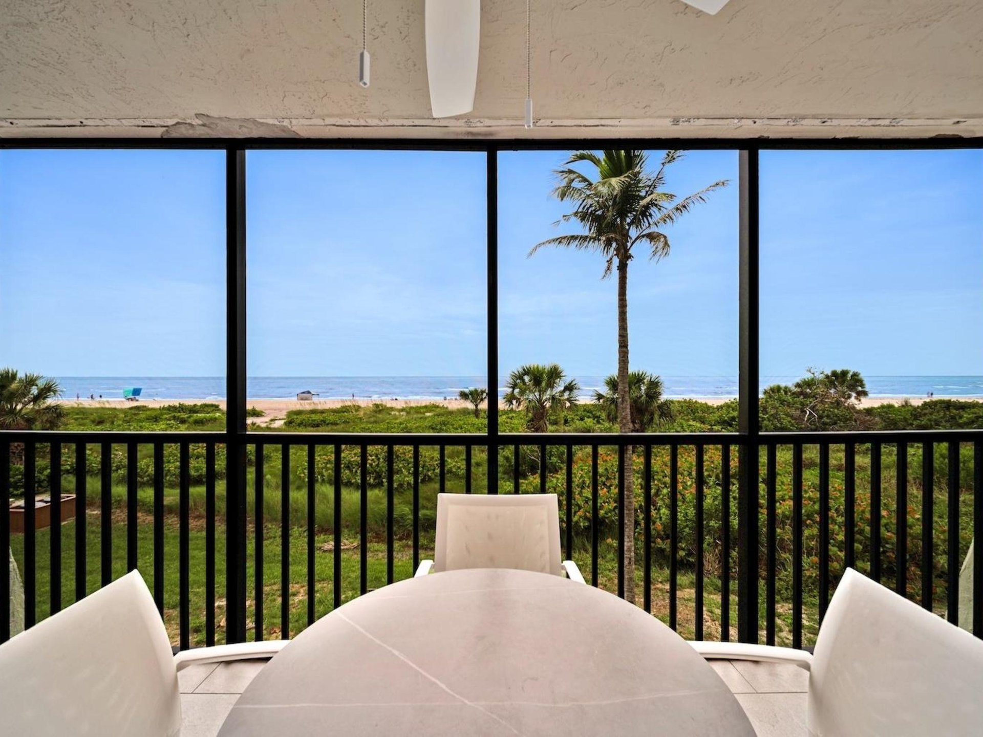 A dining table and chairs on a private balcony