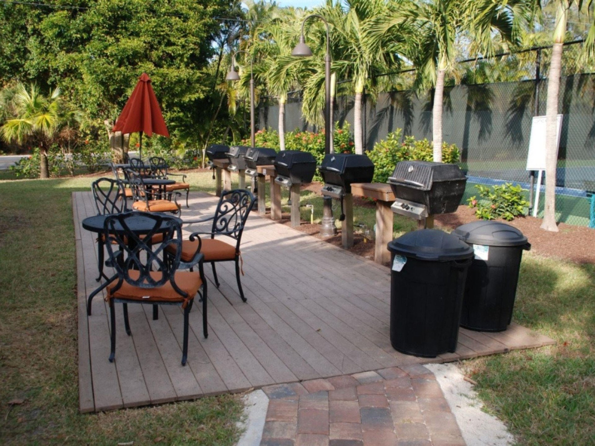 The outdoor patio with chairs, grills and tables