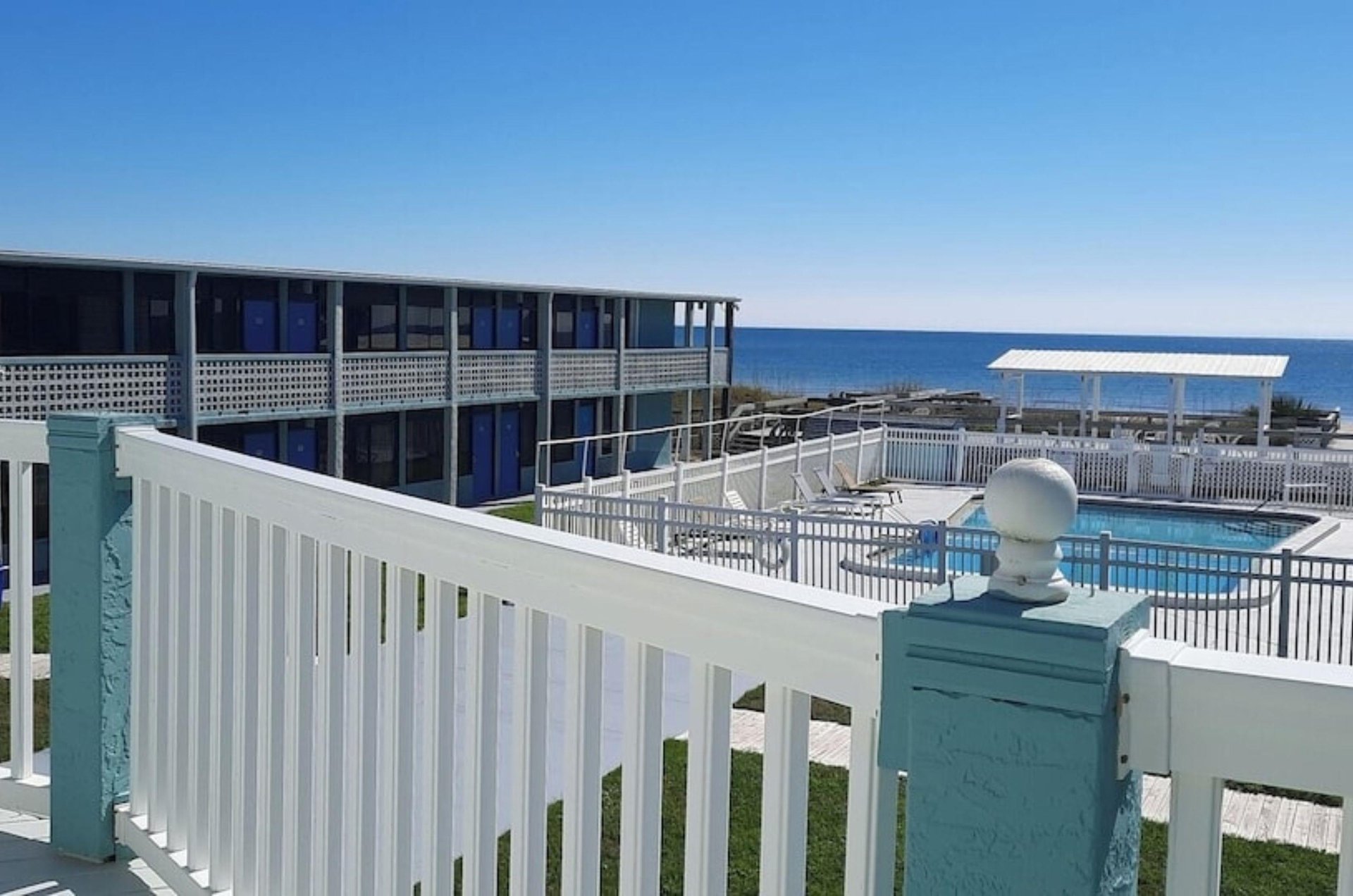 A balcony overlooking the outdoor swimming pool