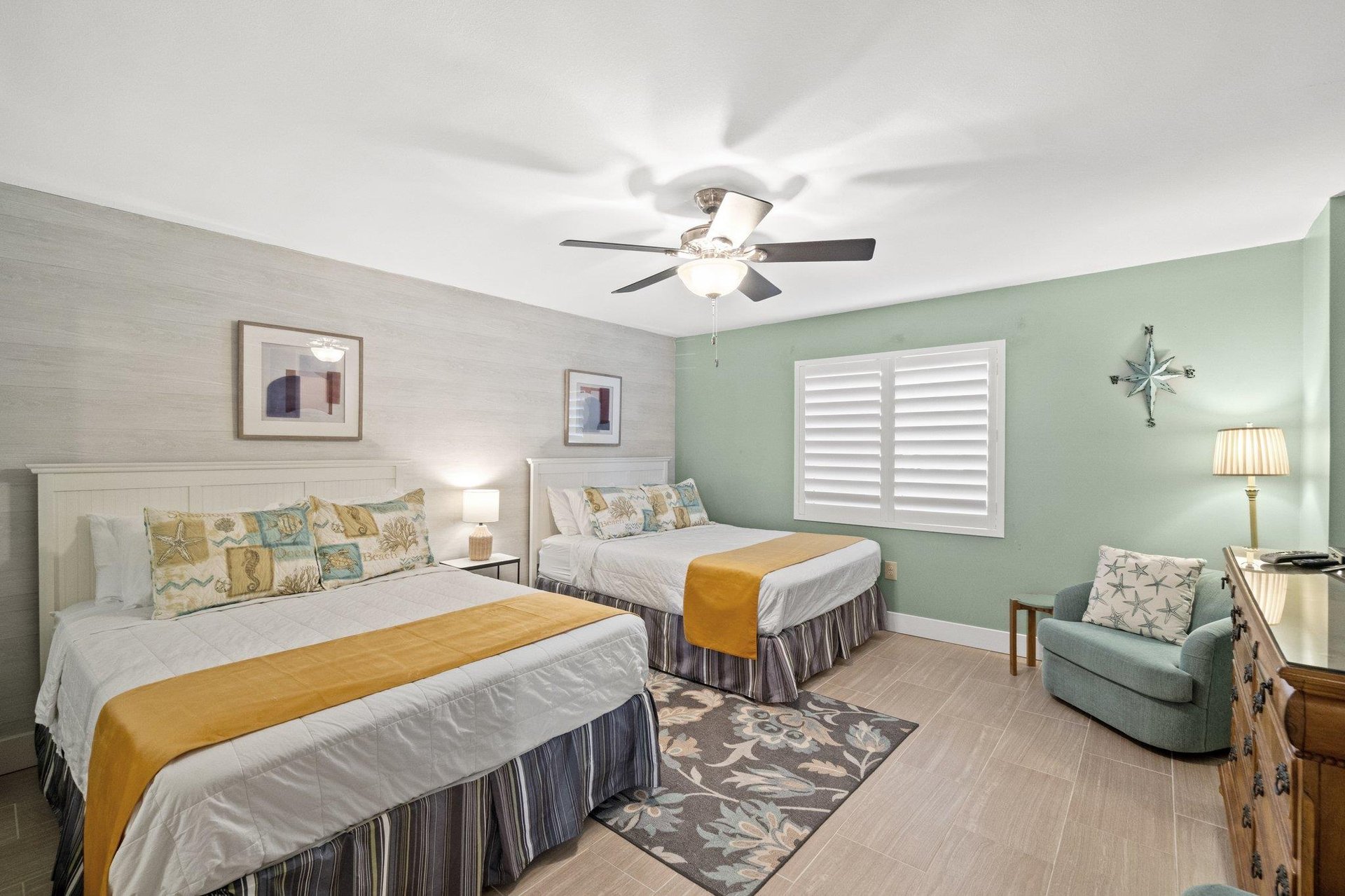 This spacious lovely guest bedroom with TWO QUEEN size beds now features Tile Flooring making for a perfect beachfront accommodation