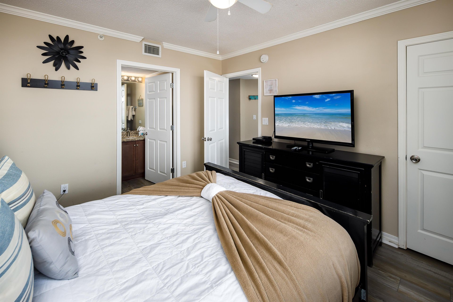 Flat screen TV and the entry to the second full bath.