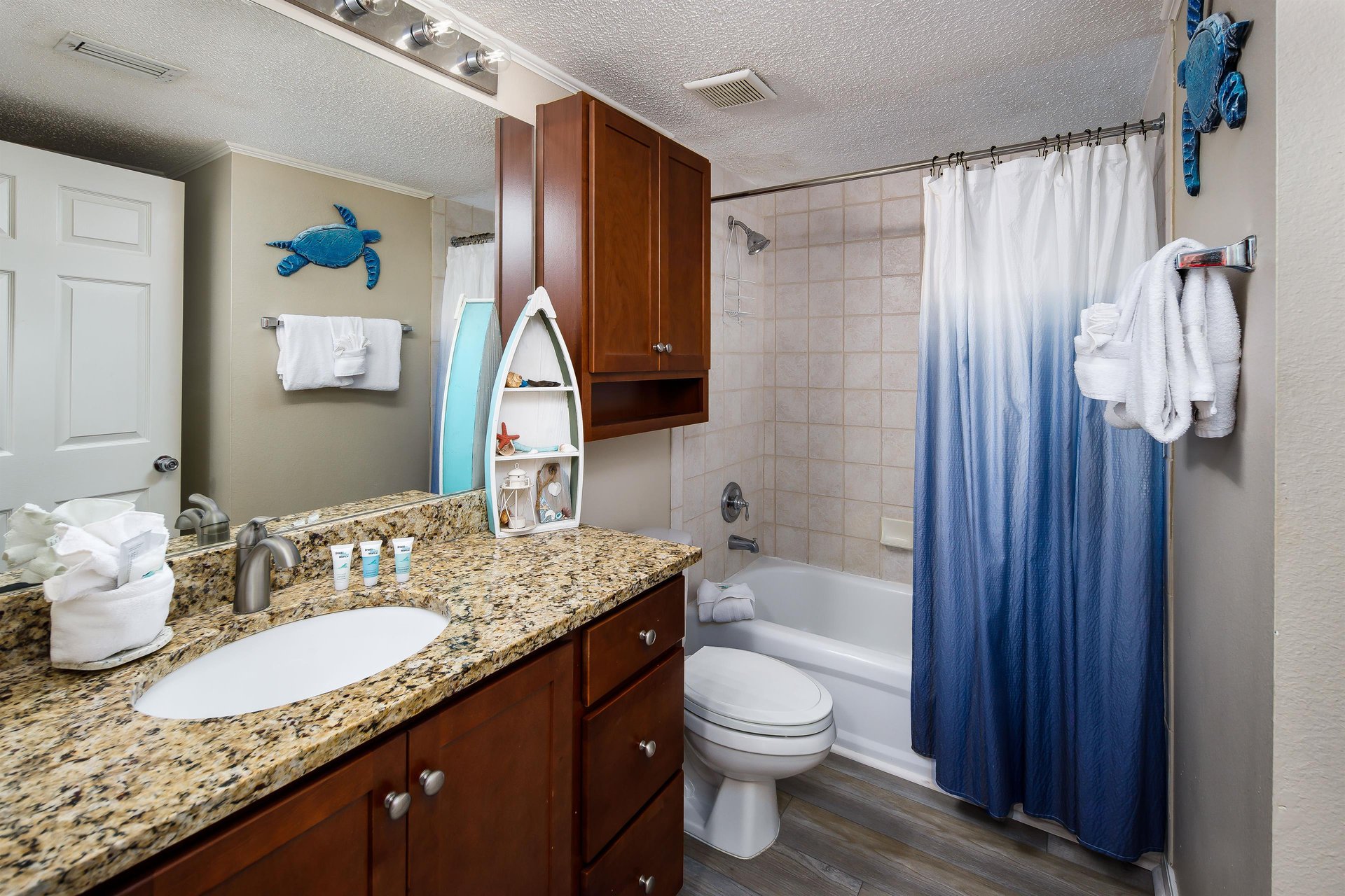 Enjoy this beach themed bathroom during your stay.  Lot of counter space for all your necessities.