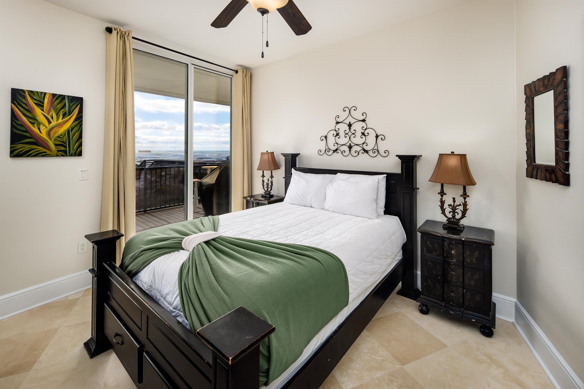 A guest bedroom with balcony access and views