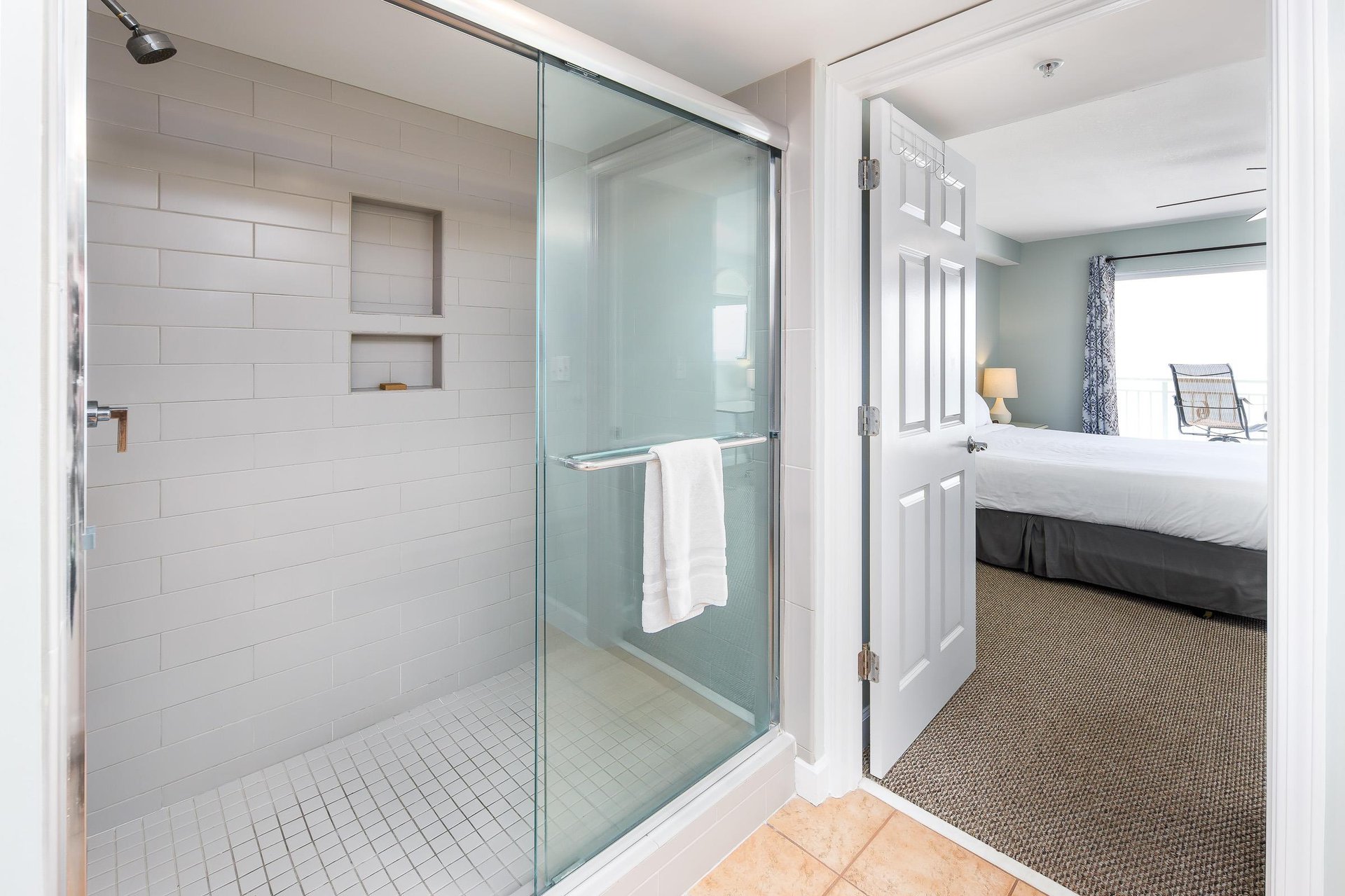 A huge shower enclosed by glass doors.