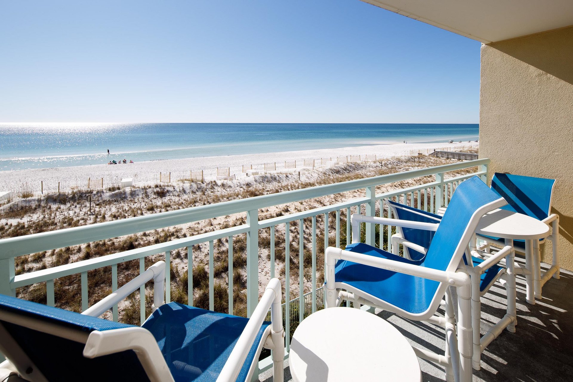 Balcony Retreat Sip drinks while soaking in stunning beach views and sunlit serenity