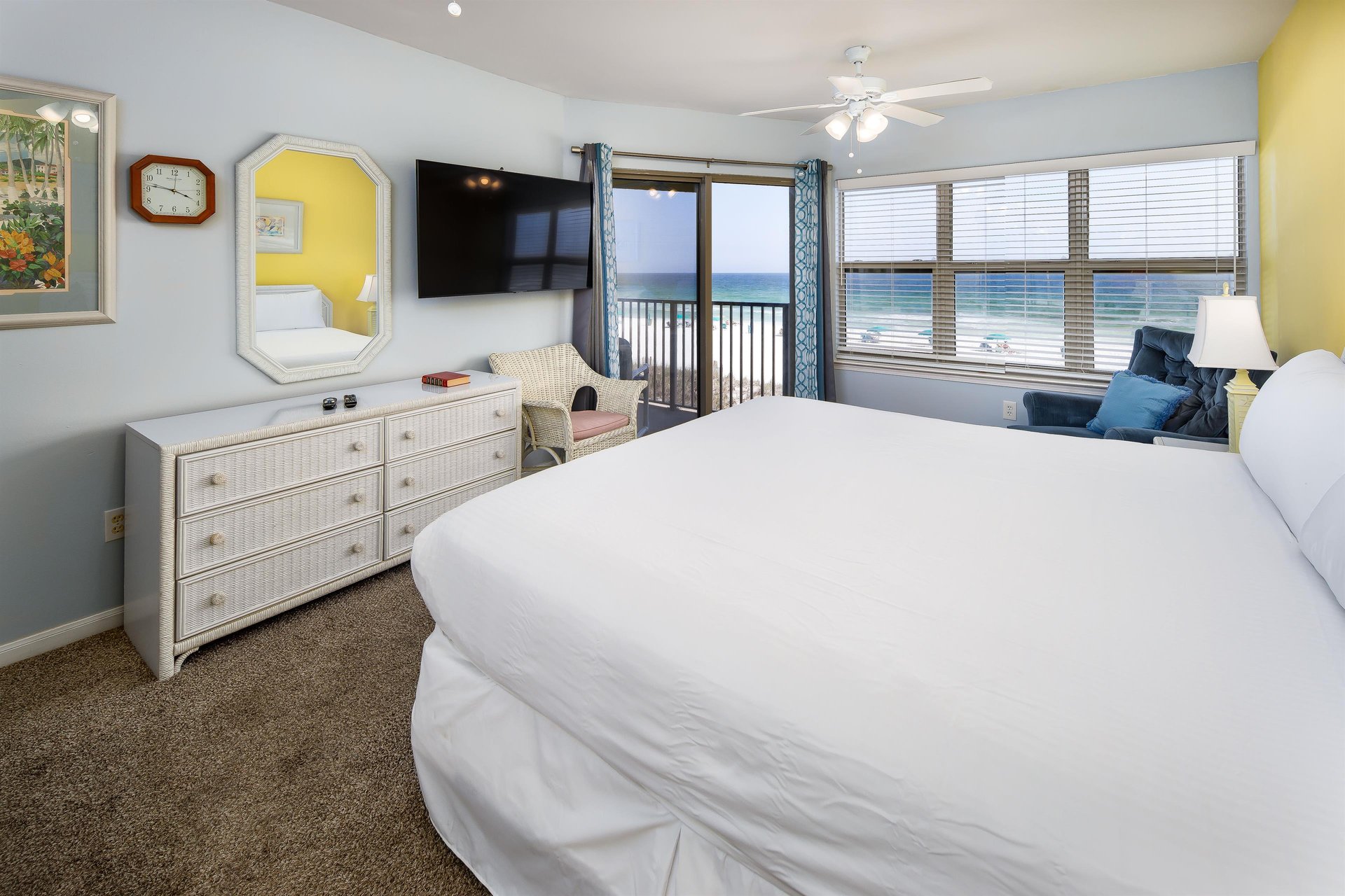 The master bedroom has a kingsized bed, rockerrecliner, Smart TV and a sliding glass door to the balcony.