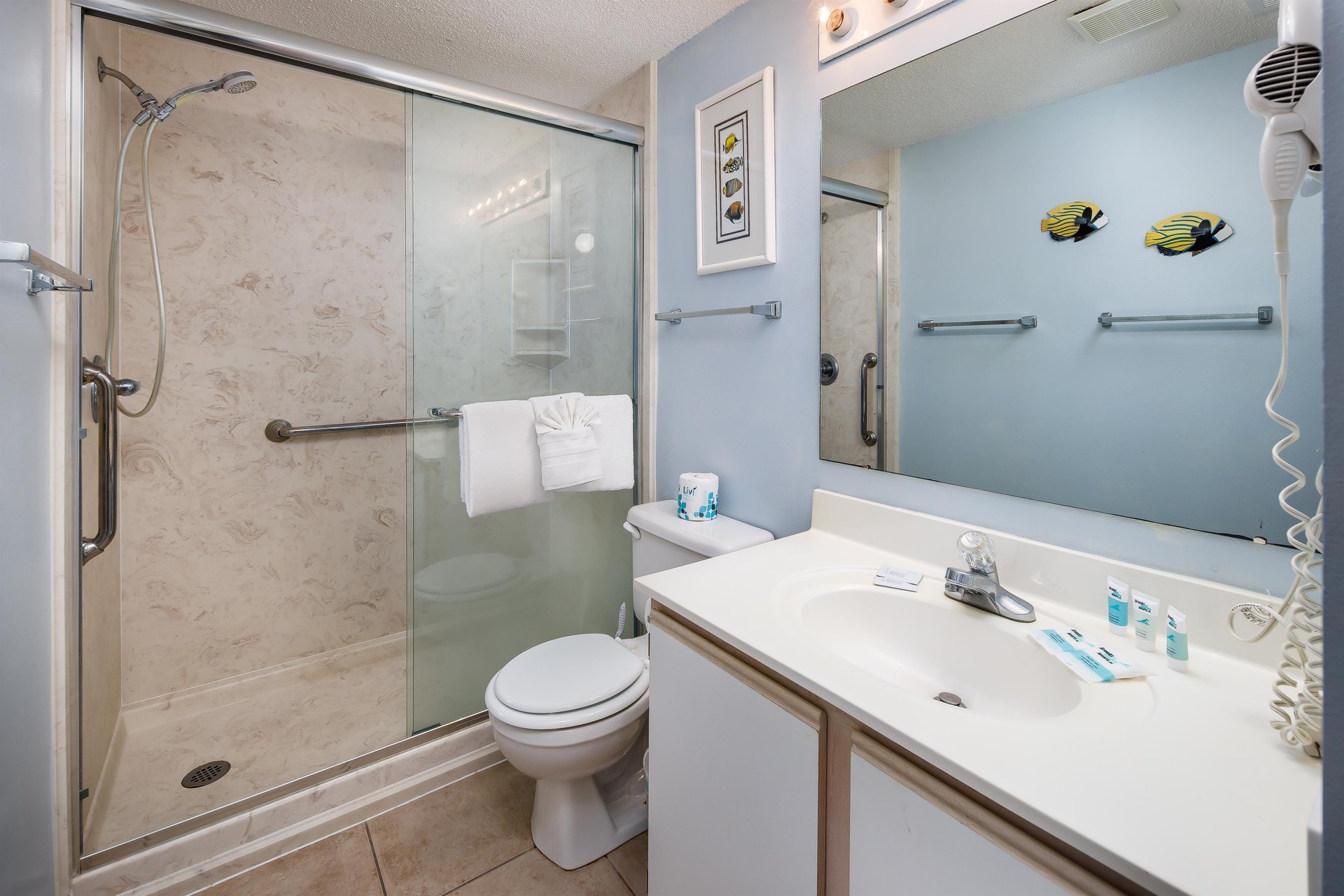 Just inside the door to the master bedroom, the master bath features a walk in shower and wallmounted hair dryer.