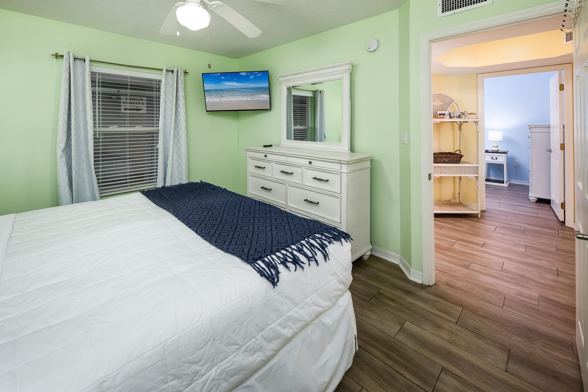 The Master Bedroom has a full en suite bath and a King sized bed facing a mounted TV
