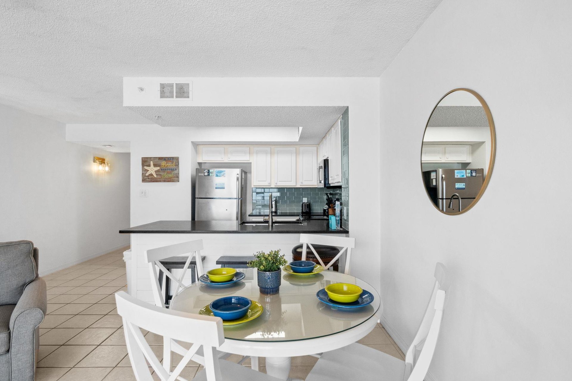 The dining table is close to the kitchen for convenience.