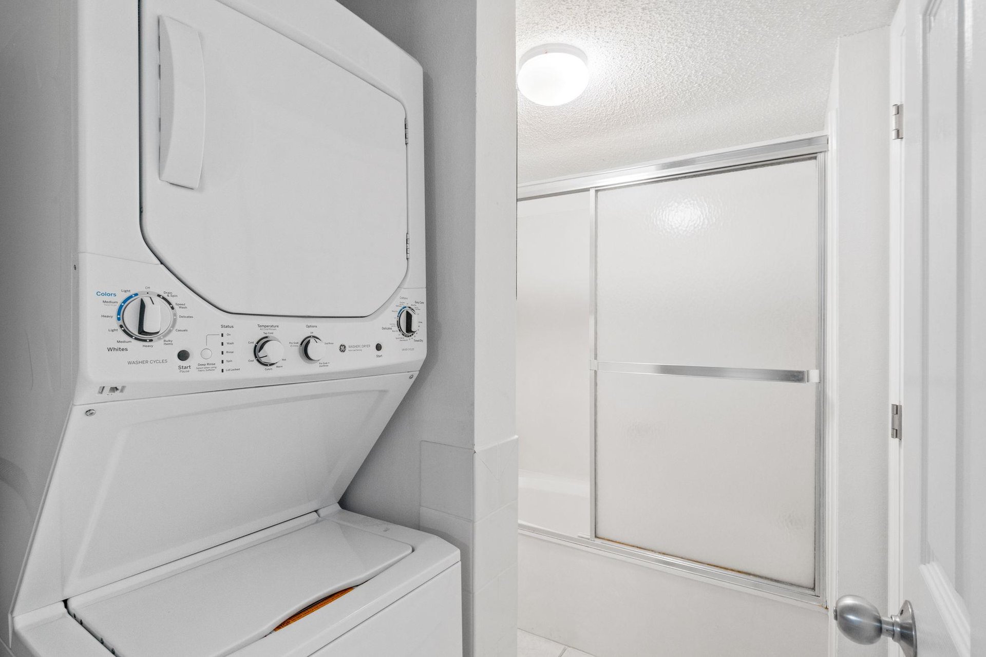 Washer  dryer area, as well as a tub  shower combo.