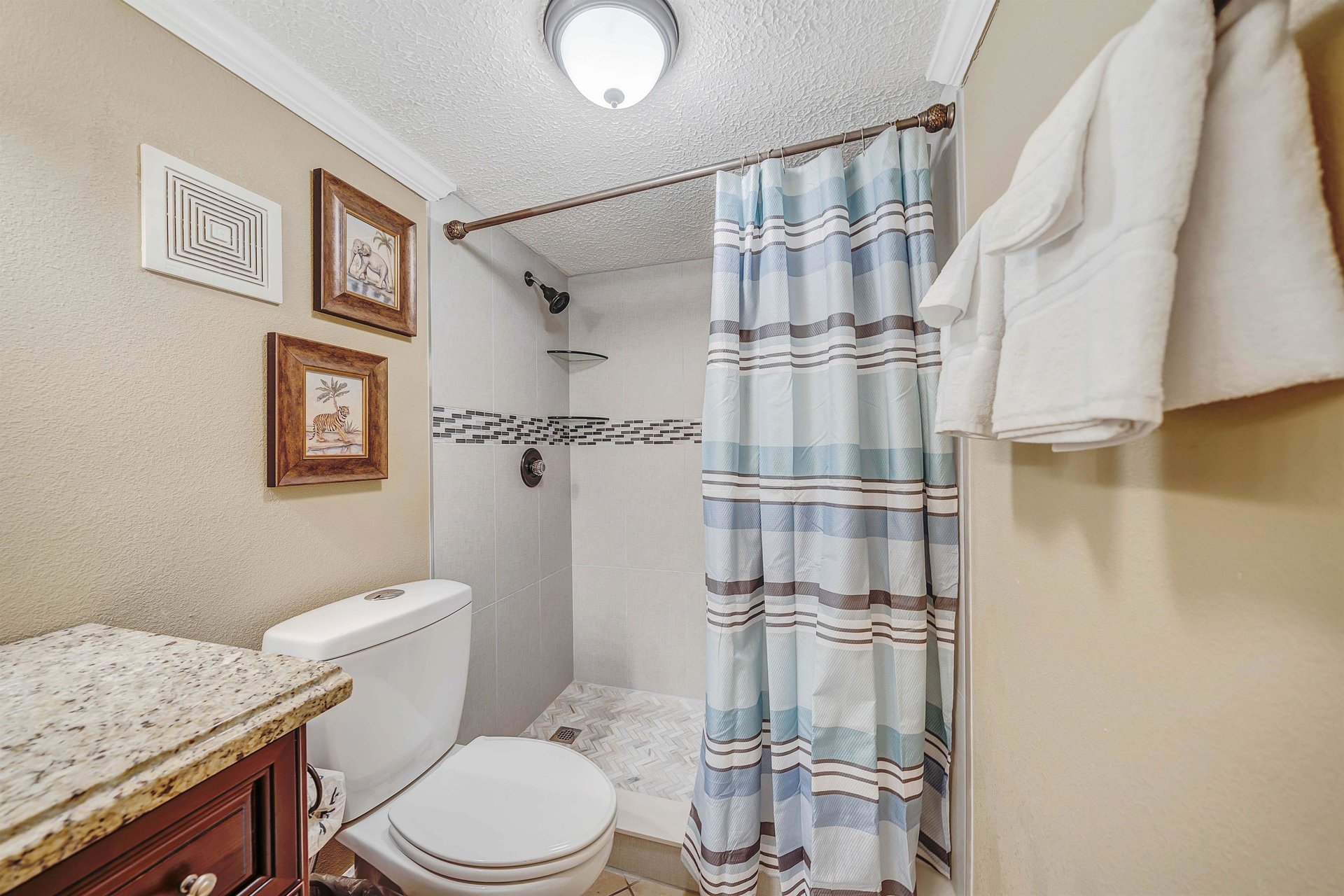 The ensuite bathroom features a beautiful vanity and tubshower combo.